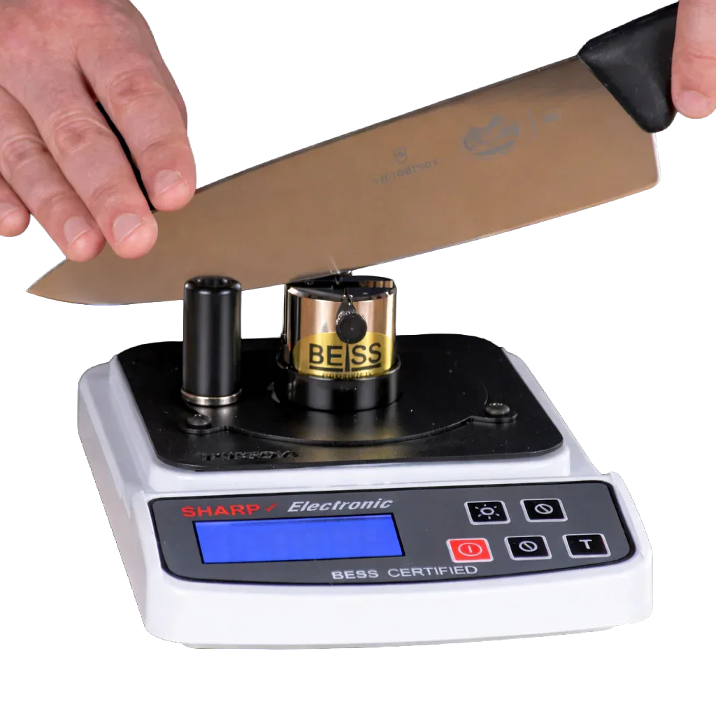 Hands pressing a knife into a sharpness tester on a blank background.