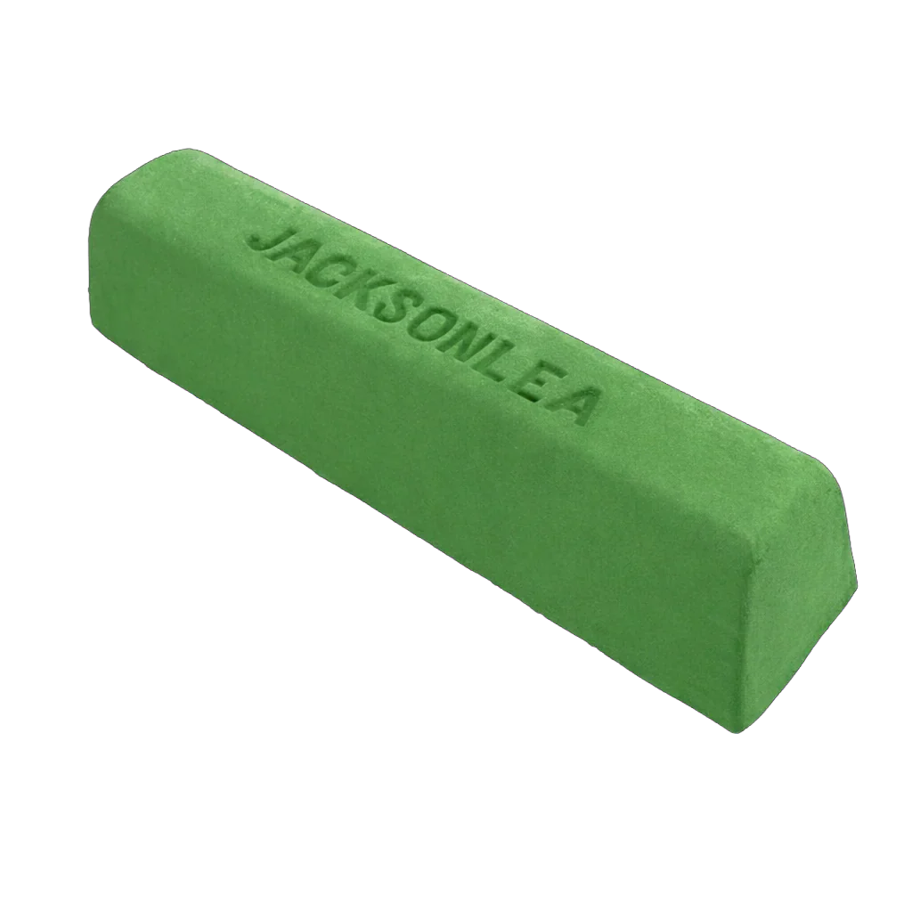 Green stick of buffing compound on a white background.